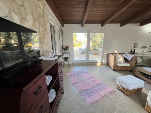 a living room with a kitchen with a couch and a table at Villa dei Venti in Ostuni