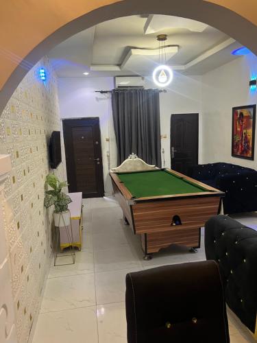 a living room with a pool table in it at Destymond Apartment warri in Warri