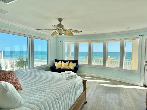 a bedroom with a bed with a view of the ocean at Moonlight Sonata-Beachfront-Community Pool in St. George Island