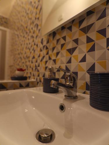 a sink with a faucet in a bathroom at Casa Giudea in Brindisi