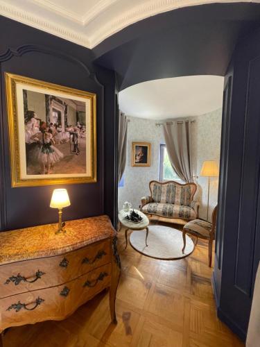 a living room with a couch and a table at Château Philip in Saint-Genest-Lerpt