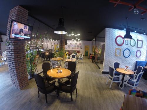 a restaurant with tables and chairs in a room at Cinema Boutique Hotel in Ganja