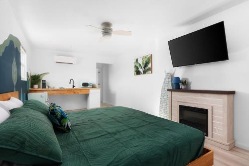 a bedroom with a bed with a fireplace and a flat screen tv at Motel Miya in Rockport