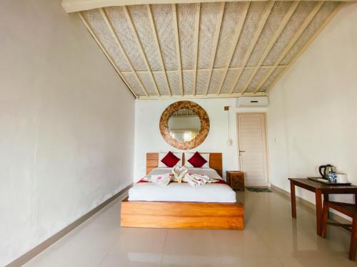 a bedroom with a bed and a wooden ceiling at Villa Olala Penida in Toyapakeh