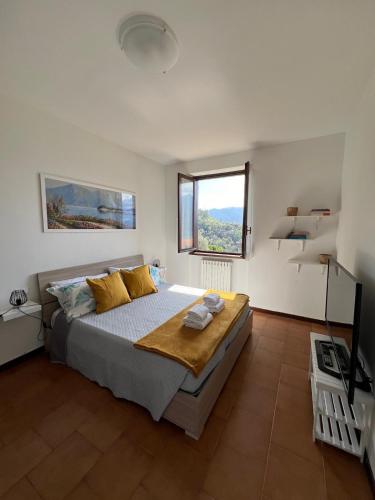 a bedroom with a large bed and a window at Casa NiMa Lake Apartment in Perledo