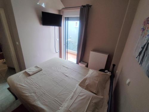 a small bedroom with a bed in a room at Calypso Rooms in Preveza