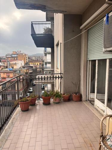 a balcony with potted plants on a building at LG Appartamento Turistico Giarre in Giarre