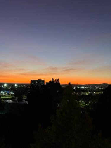 a view of a city at sunset at Vista Laguna Redonda in Concepción