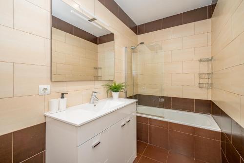 a bathroom with a sink and a shower and a tub at Plaza España Superb Views in Madrid