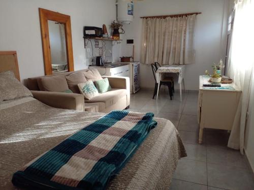 a living room with a couch and a table and a kitchen at Departamentos Fabio in Federación