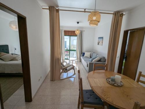 a living room with a table and a couch at GP Guest House in Alvor