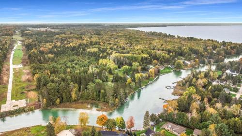 an aerial view of a river with trees and houses at The Swimmin Hole in Cheboygan