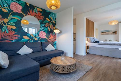 a living room with a couch and a bed at Fewo Butze Fiev in SPO ⇒ Traumurlaub an der Nordsee in Sankt Peter-Ording