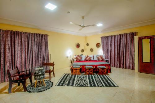 a bedroom with a red bed in a room at Sealine View Hospitality Centre in Oblogo