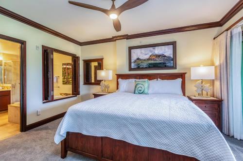 a bedroom with a large bed and two lamps at Waipouli Beach Resort E301 in Kapaa
