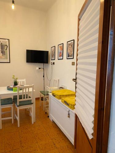 a room with a bed and a table and a desk at Tower Pisa apartment in Pisa