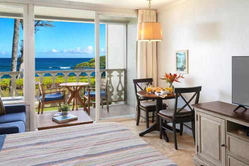 a bedroom with a room with a view of the ocean at Islander on the Beach 246 in Wailua