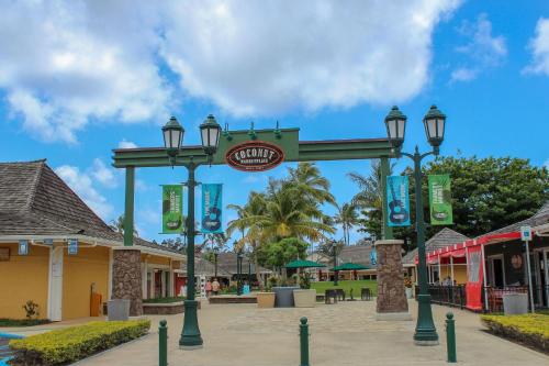 a sign for a shopping center with street lights at Islander on the Beach 246 in Wailua