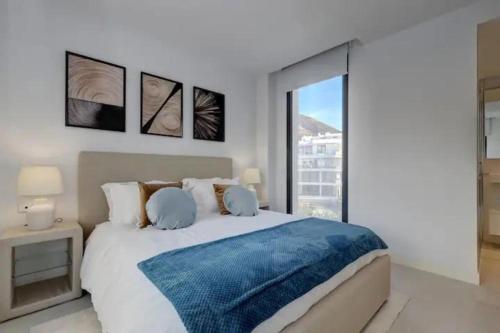 a bedroom with a large bed and a large window at VIVI Homes - Bossa Nova in Fuengirola