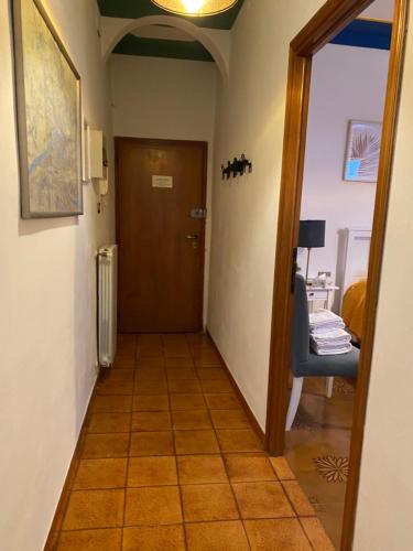 a hallway with a door and a chair in a room at Tower Pisa apartment in Pisa