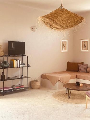 a living room with a couch and a tv at Antica Masseria le Monache in Grottaglie