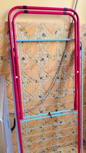a wire cage full of donuts on a wooden floor at Elegant 2 BR Apartment Kileleshwa - Free Netflix, Parking, Superfast WIFI, Views of Arboretum in Nairobi