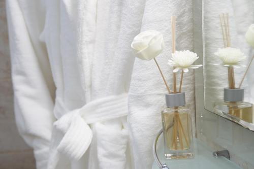 a vase with white flowers in it on a table at Family hotel The Castle in Shumen