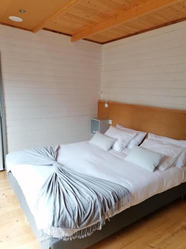 a bed with white pillows in a room at Quinta Mata da Sé in Miranda do Corvo