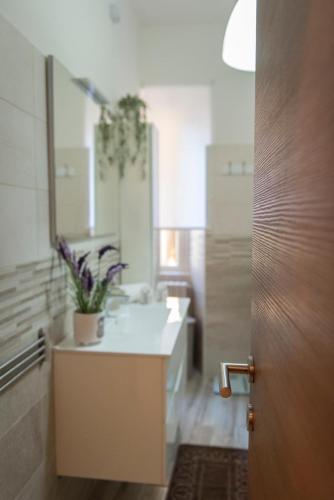 a bathroom with a white sink and a mirror at Casa Lucrezia - alla Torre in Viterbo