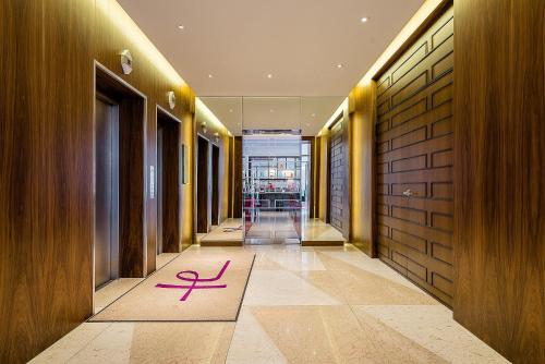 a hallway with a pink symbol on a rug on the floor at Hotel Europa in Munich