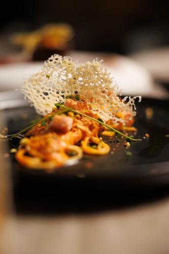 a plate of food with rice on top of it at Destiny Hotel & SPA in Tirana