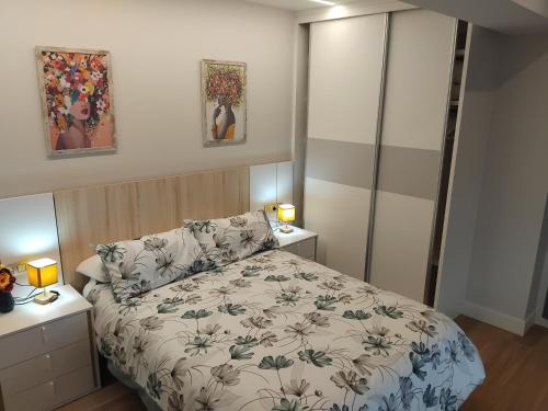 a small bedroom with a bed and two night stands at La Barbacana in Laguardia