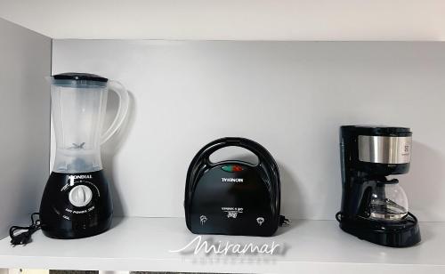 a blender sitting on a shelf next to a appliance at Move - Tambaú in Tambaú