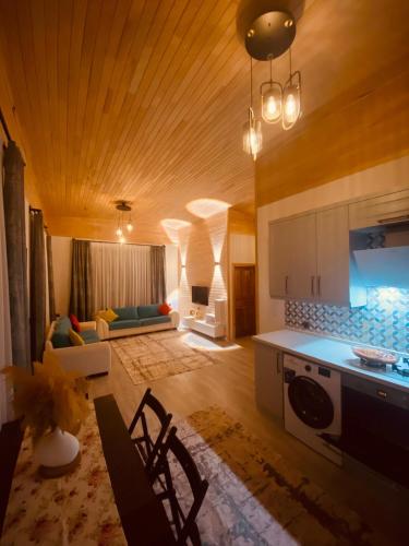 a kitchen and living room with a couch and a table at Black Cat Villa's in Kemer