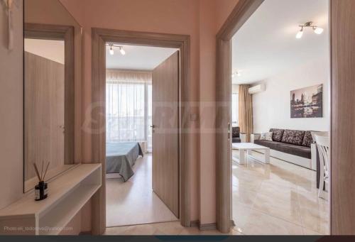 a room with a door leading to a living room at La Mer Welcome in Golden Sands