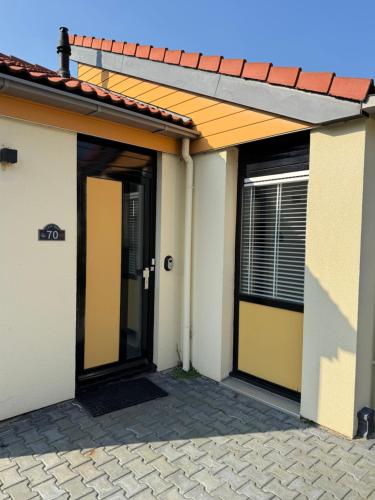an open door of a house with a roof at Casa Bep in Zevenhuizen