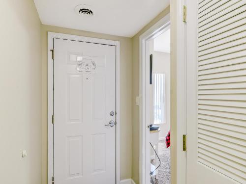 a white door in a hallway next to a house at Lazy Bear Whispering Pines 111 in Pigeon Forge