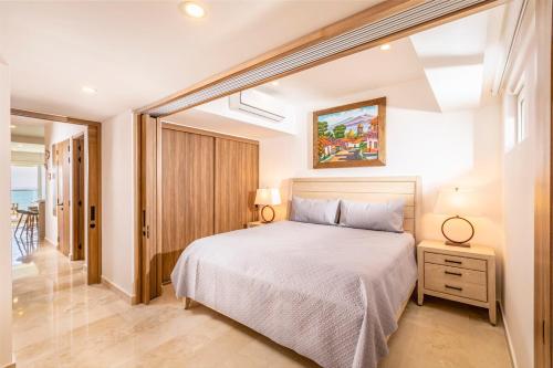 a bedroom with a large bed and a window at Harbor NT2505 by Moikkarentals in Puerto Vallarta