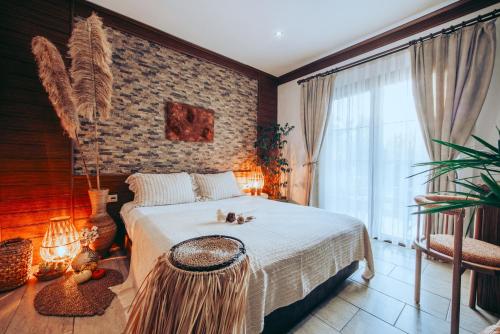 a bedroom with a bed and a large window at Mesken Inn Göcek Hotel in Göcek