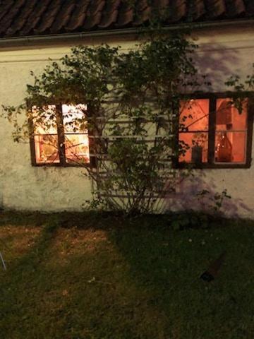 a house with two windows on the side of it at Ekeskogs in Fole