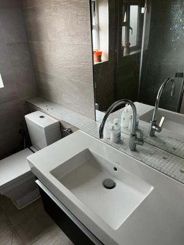 a white bathroom with a sink and a toilet at Vf apartments kingsbury in The Hyde
