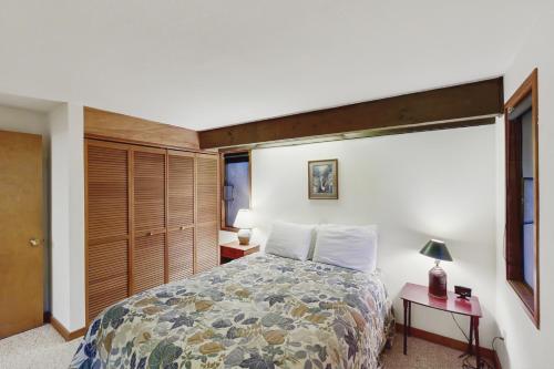 a bedroom with a large bed and a window at The Eagle's Nest in Otis