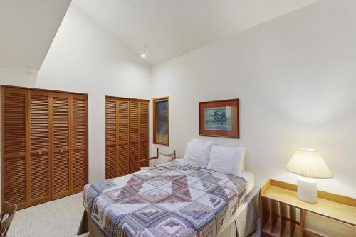 a bedroom with a bed and a desk and a lamp at The Eagle's Nest in Otis
