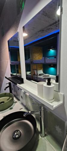 a bathroom with a sink and a mirror at "The Sisters' Hostel" the women only hostel in Adeje