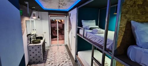 a small room with two bunk beds in it at "The Sisters' Hostel" the women only hostel in Adeje