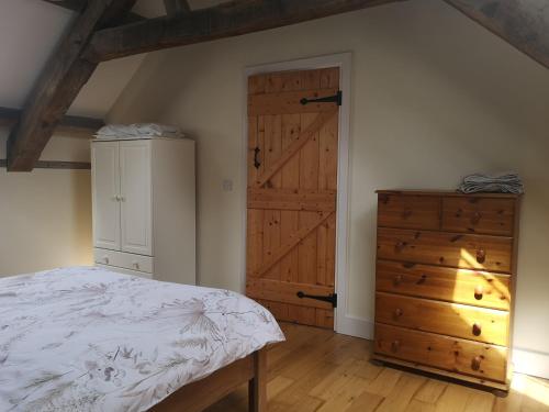 a bedroom with a bed and a wooden door at Clashganny mill in Borris