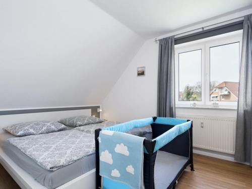 a bedroom with a bed and a large window at holiday apartment with 2 bedrooms in Timmendorfer Strand