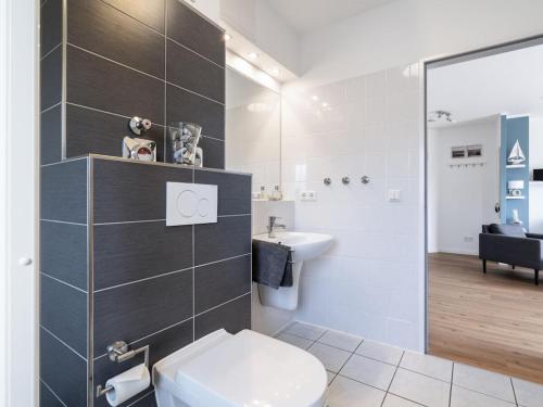 a bathroom with a toilet and a sink at holiday apartment with 2 bedrooms in Timmendorfer Strand