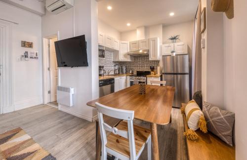 a kitchen with a wooden table in a room at North House - Des Remparts- 2-bed with great views, terrace in Quebec City