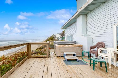 a wooden deck with a view of the ocean at Gleneden BeachFront Getaway in Lincoln Beach
